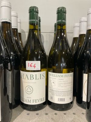 des bouteilles de vin sont alignées sur une étagère dans un réfrigérateur