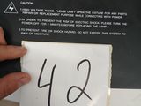 someone is holding a piece of paper with the number 442 written on it