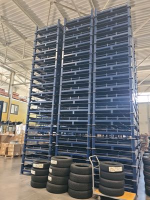 a large stack of tires sitting on top of a pallet in a warehouse