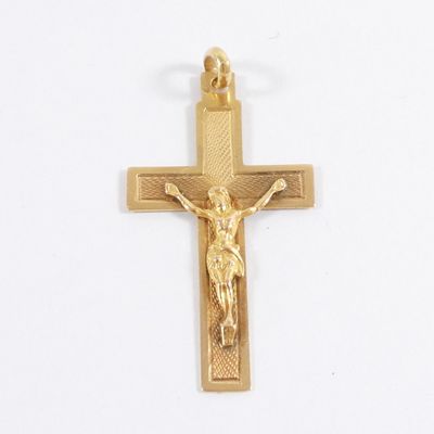 gold plated crucifix with a cross on a white background