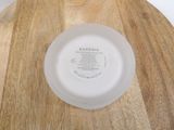 a white plate sitting on top of a wooden table