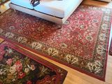 an image of a living room with a couch and rugs