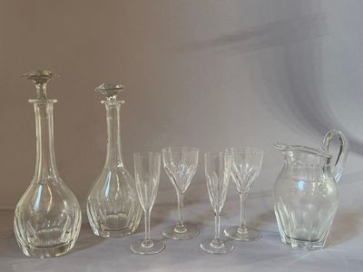 a group of wine glasses and a decanter on a table