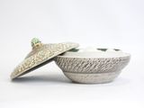 an image of a white bowl with a lid and a spoon in it