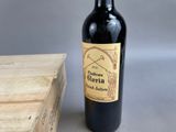 a bottle of wine sitting next to a wooden box