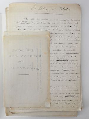two old papers with writing on them sitting on a table