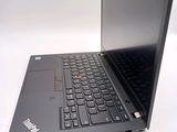 a laptop with a black keyboard on a white surface
