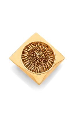an image of a gold plate with a flower design on it