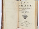 an old book opened to show the title of a novel