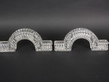 a pair of clear glass candlestick holders on a black background