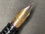 a close up of a fountain pen on a table