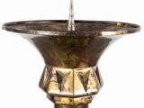 a metal candle holder with a candle in it