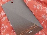 a close up of a red dress with a tag on it