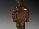 an image of a wooden statue of a man with a hat on his head