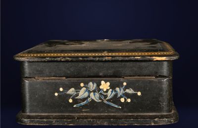a small black box with birds painted on it