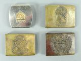 four different types of silver and gold belt buckles on a white surface