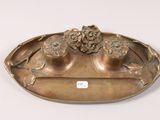 a metal tray with flowers on it on a white surface