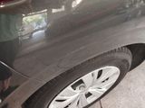 a black car that is parked on the side of the street