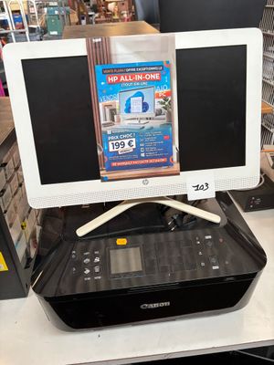 two monitors on top of a printer on a table