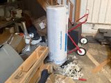 a pile of boxes and a cart in a garage