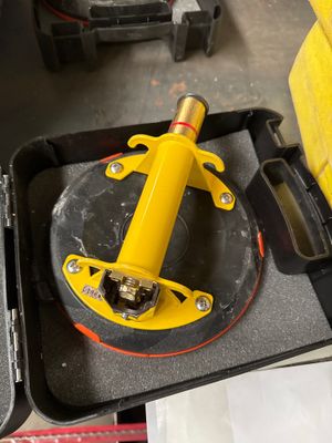 a yellow tool sitting in a black case on a table