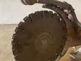 someone is using a circular saw to cut a piece of metal