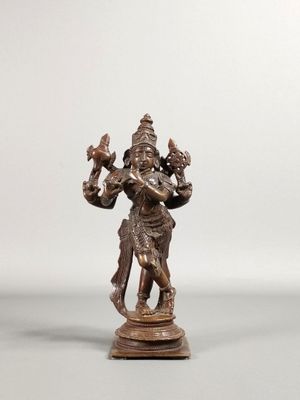 une image représentant une statue en bronze d'une personne tenant un oiseau