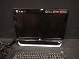 a laptop computer sitting on a desk with a keyboard