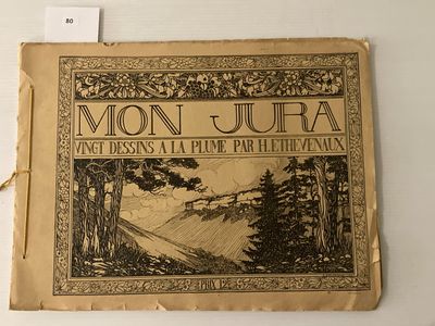 un vieux livre sur lequel figure l'illustration d'un paysage de montagne
