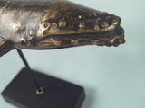 a statue of a whale on a stand on a table
