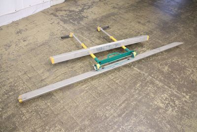 a pair of skis laying on the floor in a garage