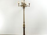 a brass plated floor lamp with three lamps on each end