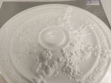 a white plate with a decorative design on it on a table