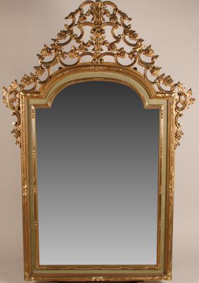 un miroir sculpté avec un cadre doré sur fond blanc