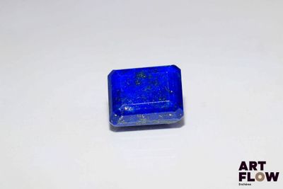 a small square blue object on a white surface