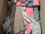 a box full of clothes that is sitting on the floor