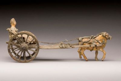 statue of a horse pulling a cart with a man on it