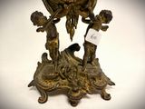 a bronze figurine of a boy and a girl on a table