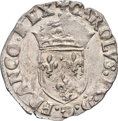 une pièce d'argent surmontée d'une couronne