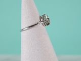 a close up of a ring on a white cone with a blue background