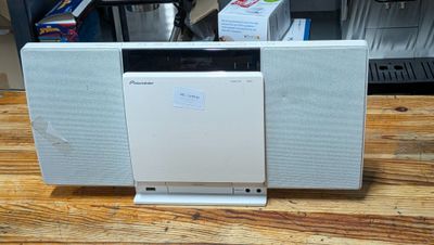 a white dishwasher sitting on top of a wooden table
