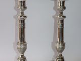 pair of silver candlesticks on a white background