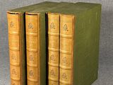 three books are stacked on top of each other on a gray surface