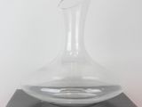 a clear glass vase sitting on top of a black box