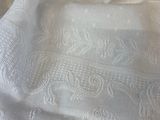 a close up of a white table cloth on a table