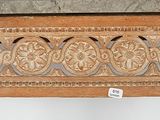 a marble top table with a carved design on it