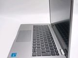 a silver laptop with a blue sticker on it