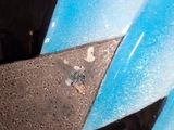 a close up of a helmet with a blue and black design on it