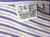 a close up of a label on a blue and white striped shirt
