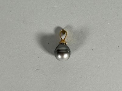 an image of a black pearl pendant on a white surface
